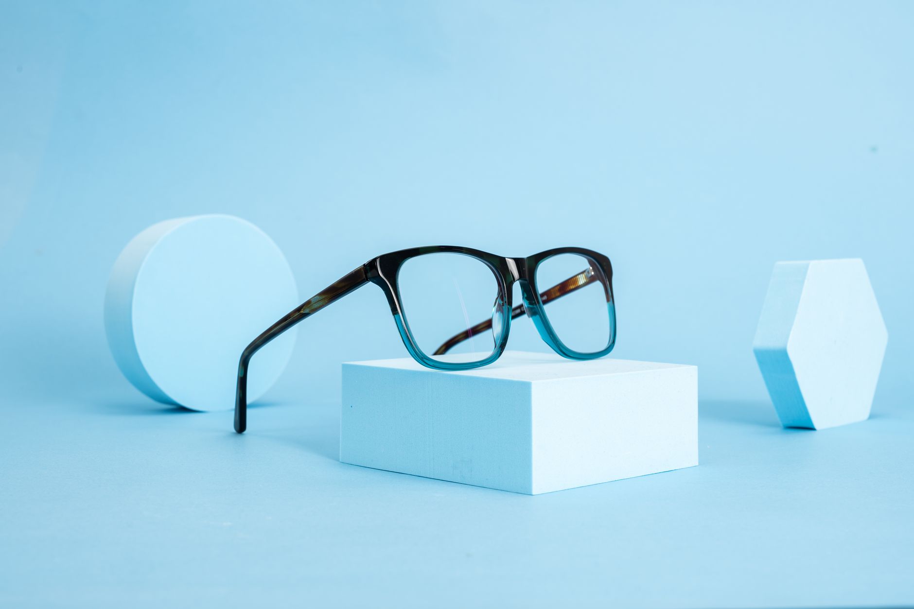 A pair of eyeglasses photographed in a studio